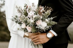 Is polygamy legal in Australia? Photo depicting marriage of bride and groom holding flower bouquet