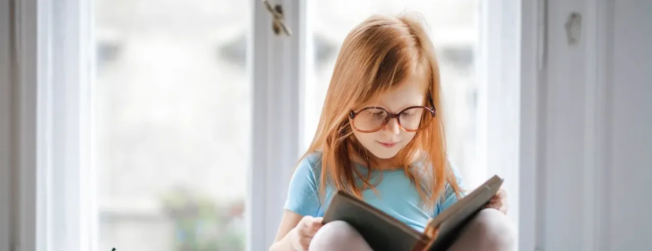 This young child is reading about the benefits of parenting coordination